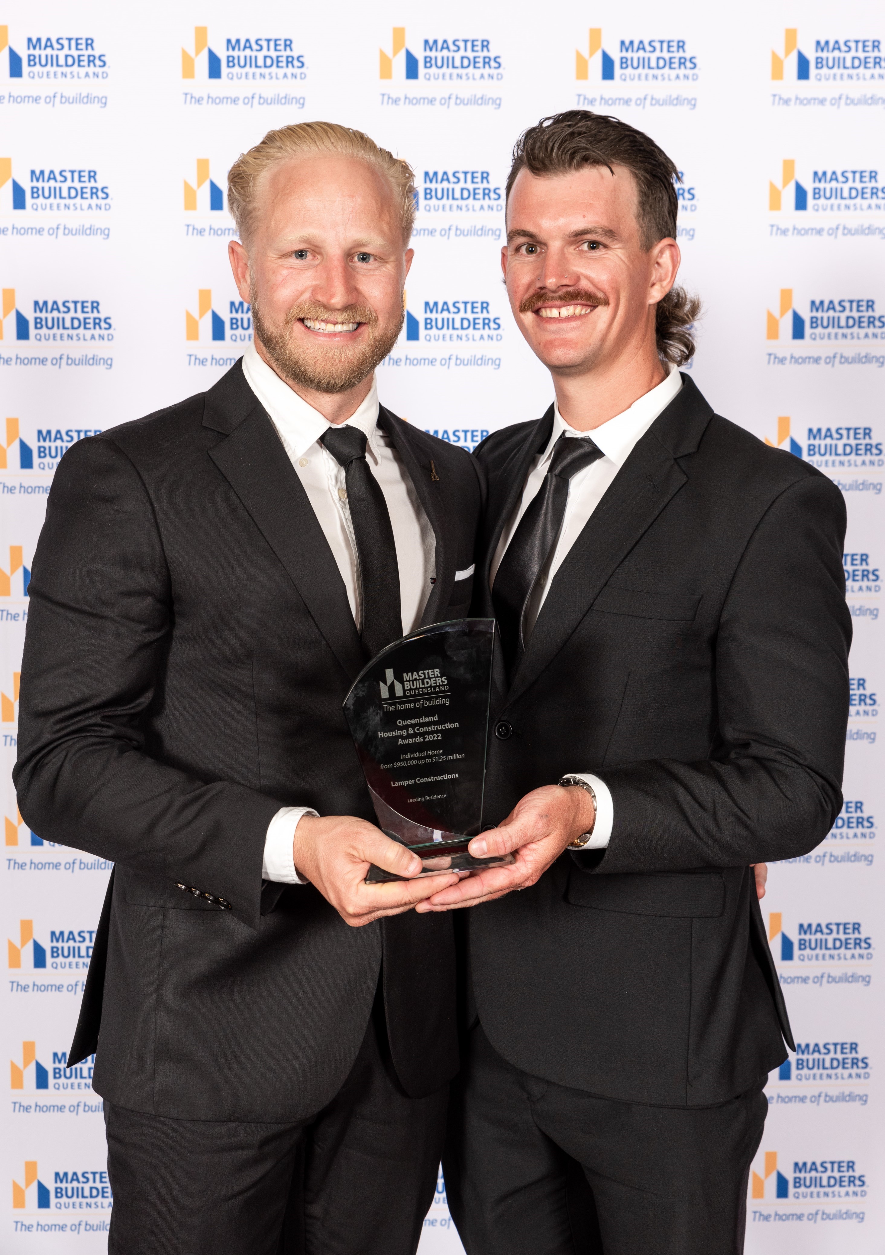 Two men smiling with their Housing & Construction Award